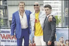  ?? BY JOERG CARSTENSEN/DPA VIA AP CONTRIBUTE­D ?? Actors David Hasselhoff, from left, Dwayne Johnson and Zac Efron pose during a photo call prior to the European premiere of “Baywatch” in Berlin on Tuesday.