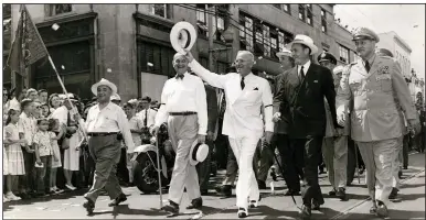  ??  ?? President Harry S. Truman waves to the crowd as he and Gov. Sid McMath (right of Truman) lead a parade of veterans down Little Rock’s Main Street on June 11, 1949.
(Democrat-Gazette file photo)