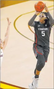  ?? Darryl Webb The Associated Press ?? Stanford forward Francesca Belibi lines up a shot over Arizona State guard Taya Hanson in the second quarter of the top-ranked Cardinal’s 68-60 win Sunday at Desert Financial Arena. Belibi had 23 points and 12 rebounds.