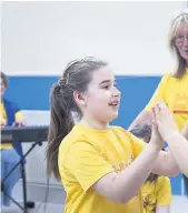  ??  ?? Enjoyable experience Teri Neeson, 9, and Karen Neeson, 10, have fun as June Thomson from Ballet Bees looks on