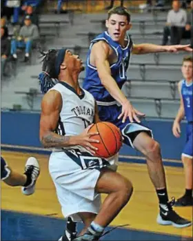  ??  ?? Pottstown’s Larry Wingo drives to the hoop while Lower Dauphin’s Kyle Korzinski defends.