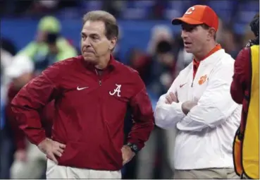  ?? GERALD HERBERT — THE ASSOCIATED PRESS ?? Alabama coach Nick Saban, left, and Clemson coach Dabo Swinney talk before the Sugar Bowl College Football Playoff semifinal on Jan. 1, 2018, in New Orleans.