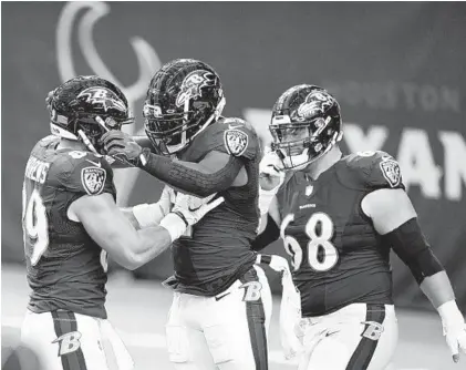  ?? MATT PATTERSON/AP ?? Ravens running back Mark Ingram II (center) celebrates with Mark Andrews (89) after scoring a touchdown against the Texans.