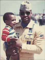  ?? JD Dillard ?? BRUCE DILLARD, the second African American Blue Angel, holds his son, director JD Dillard, in 1989.