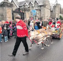  ??  ?? Meeting the people Santa Day in previous years has drawn big crowds to watch the festive sleigh pass through Birnam and Dunkeld