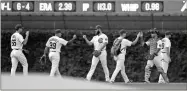  ?? Chris Sweda/Chicago Tribune/TNS ?? Cubs pitcher Jake Arrieta (center) walks in from the bullpen before his start against the Brewers at Wrigley Field on Aug. 11.