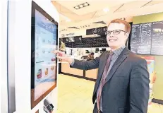  ?? FOTO: JÖRG KNAPPE ?? Tim Seibert,Pressespre­cher im McDonald’s-Servicecen­ter Froitzheim, zeigt eines der neuen digitalen Bestellter­minals mit Touchscree­n.