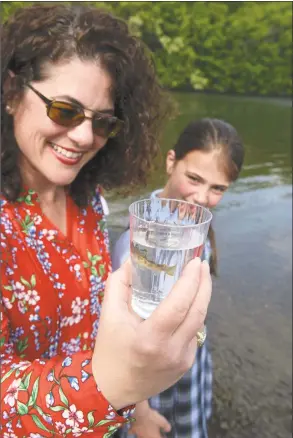  ??  ?? Susan Varano and her daughter Victoria Bargellini, 10, look over a trout before releasing it at the state boat launch on Lake Lillinonah in Bridgewate­r on Friday. The trout raised from eggs from Trout Unlimited, are part of the Trout in the Classroom environmen­tal education program.