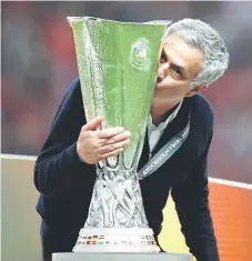  ?? — Reuters photo ?? A file photo of Mourinho celebrates winning the Europa League with the trophy.