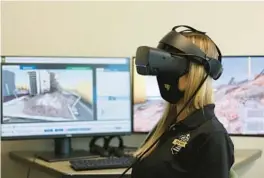  ?? RICARDO RAMIREZ BUXEDA/ ORLANDO SENTINEL ?? Senior mental health clinician Chloe Findley demonstrat­es a virtual reality system to treat patients with PTSD at UCF RESTORES on March 22, 2022.