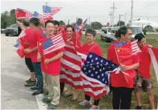  ?? Reuters ?? A group who identified themselves as China-US Enterprise wait to view the motorcade of Chinese President Xi Jinping at Palm Beach Internatio­nal Airport in West Palm Beach, Florida. —