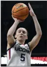  ?? (AP file photo) ?? Connecticu­t’s Paige Bueckers (left) and Azzi Fudd (right) hope, along with Coach Geno Auriemma, they will make it through the season with no injuries. Bueckers missed all of last season and most of the previous one with two knee injuries. Fudd has also missed a considerab­le amount of time during her freshman and sophomore seasons.