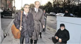  ?? PHOTO: FRANK MC GRATH ?? Troika days: The IMF’s Ajai Chopra walks past a homeless man on his way to the Central Bank, Dublin back in 2010.