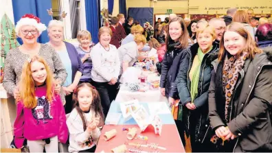  ??  ?? It’s a cracker Visitors enjoy Coylton Primary’s Christmas Fayre