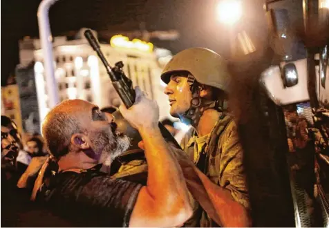  ?? Foto: Sedat Suna, dpa ?? Juli 2016: Die Türkei ist im Ausnahmezu­stand. Hier verhaftet ein Polizist einen Soldaten auf dem Taksim Platz in Istanbul.