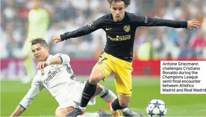  ??  ?? Antoine Griezmann challenges Cristiano Ronaldo during the Champions League semi-final encounter between Atletico Madrid and Real Madrid