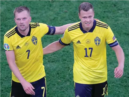  ??  ?? Sweden's Sebastian Larsson, left, walks with Viktor Claesson after the Euro 2020 soccer championsh­ip group E match between Sweden and Poland at the Gazprom Arena stadium, in St. Petersburg, Russia, Wednesday, June 23, 2021. (Maxim Shemetov /Pool via AP)