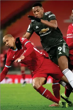  ??  ?? Fabinho goes down under the challenge of Anthony Martial as Manchester United and Liverpool shared the spoils