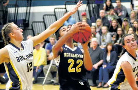  ?? JOE CSEH/SPECIAL TO POSTMEDIA NEWS ?? Notre Dame's Jamiera Rousseau, with the ball, is defended by Sir Winston Churchill's Janee Harrison, No. 12, and Kaley DeMont in Tribune Girls Basketball Tournament championsh­ip action Saturday night in Welland.