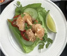  ?? tns ?? BIG ON FLAVOR: Cornstarch-dusted fried shrimp is the star of these easy-to-compose lettuce wraps with quickly pickled veggies.