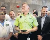  ?? CARLINE JEAN/SOUTH FLORIDA SUN SENTINEL ?? Publix employee Christian Garcia, 23, center, is recognized by Publix for helping Matthew Seese, right.