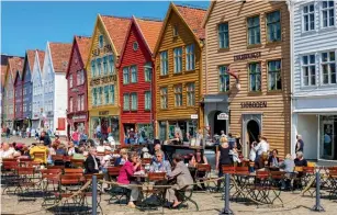  ??  ?? Outdoor eating and socialisin­g (from another era) at Bryggen in the city of Bergen, Norway (p166)