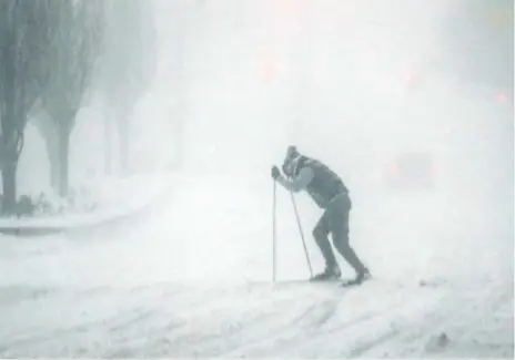  ?? KENA BETANCUR/AFP/GETTY IMAGES ?? A man skis across a street in Manhattan Saturday as a potentiall­y record-breaking storm buried New York City in up to 75 cm of snow.