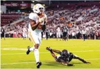  ?? TENNESSEE ATHLETICS PHOTO ?? Tennessee senior receiver Josh Palmer hauls in the winning touchdown catch during Saturday night’s opening 31-27 win at South Carolina.