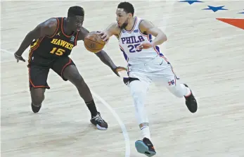  ?? Tim Nwachukwu / Getty Images / AFP ?? Philadelph­ia 76ers’ Ben Simmons gets past Atlanta’s Clint Capela during game 7 of the Eastern Conference semi-finals in June.