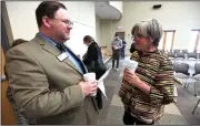  ?? NWA Democrat-Gazette/J.T. WAMPLER ?? Lisa Cordes (right), director of artist services for Mid-America Arts Alliance, visits Monday with Patrick Ralston, director of the Arkansas Arts Council, at the Bentonvill­e Public Library before an announceme­nt about the Artist 360 program. The...