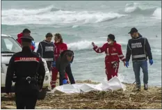  ?? ANTONINO DURSO — LAPRESSE VIA AP ?? Italian Red Cross volunteers and coast guards recover a body after a migrant boat broke apart in rough seas near Cutro, southern Italy, on Sunday. Rescue officials say an undetermin­ed number of migrants have died and dozens have been rescued off southern Italy.