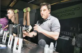  ??  ?? Keith Karp, of Royal Oaks, Mich., and Cannabinoi­d Creations dispenses hemp soda at his booth Friday at the World Medical Cannabis Conference, held at the David L. Lawrence Convention Center, Downtown. Mr. Karp said their products only contain...