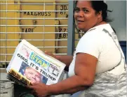  ?? PHOTO: AP ?? A Filipino newspaper vendor holds newspapers with headlines on the US presidenti­al elections yesterday. President-elect Donald Trump’s victory leaves climate change efforts in limbo.