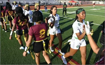  ?? BRITTANY MURRAY — STAFF PHOTOGRAPH­ER ?? Members of the Wilson and Poly girls flag football teams congratula­te each other following the Jackrabbit­s' 6-0 win Tuesday afternoon.