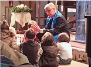  ?? COURTESY COMMUNITY OF JOY LUTHERAN CHURCH ?? Pastor Michael Bastian of Community of Joy shares with children a message on the German word “Frieden” (English Peace) to highlight the nativity story from the Gospel of Luke.