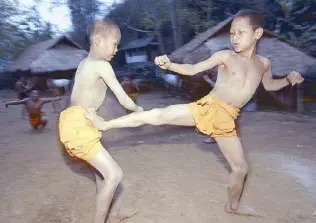  ?? AP ?? Two novice Buddhist monks practice Muay Thai (Thai kickboxing) during a morning training session at the Golden Horse Monastery in northern Thailand in this file photo.