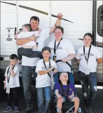  ??  ?? The Stacey family, including 5-year-old Andrew, front, poses outside their new travel trailer Sunday atthelas Vegas Motor Speedway.
