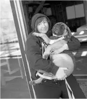  ?? MARK MAKELA/FOR THE WASHINGTON POST ?? Jenny Pacanowski carries her puppy after leading a writing workshop for combat women in Bethlehem, Pennsylvan­ia.