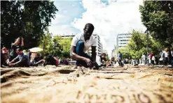  ??  ?? Ghanian artist Ibrahim Mahama performs ‘Check Point - Prosfygika’ on the main Syntagma square in Athens, in front of the Greek parliament, on April 7, 2017 on the eve of the opening of the 14th edition of the Documenta 14 art exhibition.