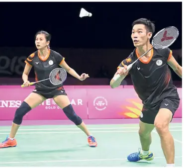  ??  ?? Winning at all costs: Malaysia’s Chan Peng Soon (right) and Goh Liu Ying in action against India’s Satwik Rankireddy-Ashwini Ponnappa in the bronze-medal playoff yesterday.