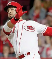  ?? (Photo by John Minchillo, AP) ?? Cincinnati Reds' Eugenio Suarez watches an RBI single off New York Mets relief pitcher Hansel Robles during the seventh inning on Tuesday.