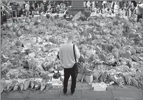  ?? AP/EMILIO MORENATTI ?? Floral tributes for the victims of the bombing Monday in Manchester, England, cover the ground Friday at the city’s St. Ann’s Square.