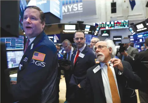  ?? (Brendan McDermid/Reuters) ?? TRADERS WORK on the floor of the New York Stock Exchange (NYSE) yesterday.