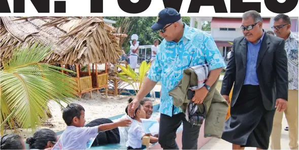  ?? Photo: Pacific Islands Forum Secretaria­t ?? Prime Minister Voreqe Bainimaram­a greeted by women and children of Tuvalu in a pool of water at Funafuti on August 11, 2019. The women and children in the water was a demonstrat­ion that the people of Tuvalu are threatened by climate change and the rising sea water.