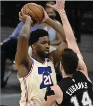 ?? DARREN ABATE - THE ASSOCIATED PRESS ?? Sixers center Joel Embiid, towering over San Antonio’s Drew Eubanks, has to play a few more games down the stretch to help his cause in the NBA MVP race.
