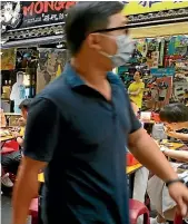  ?? AP ?? People wear face masks to help curb the spread of Covid-19 as they visit a night market in Taipei, Taiwan.