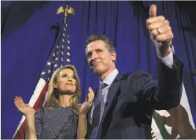  ?? David Paul Morris / Bloomberg ?? Lt. Gov. Gavin Newsom, at an election-night party in San Francisco with his wife, Jennifer Siebel Newsom, may now be facing a tougher campaign.