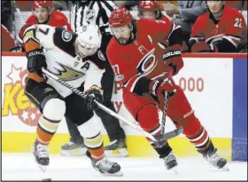  ?? Gerry Broome The Associated Press ?? Anaheim’s Andrew Cogliano, battling Carolina’s Justin Faulk for a loose puck last Sunday, has played in 800 consecutiv­e games, fourth longest in NHL history.