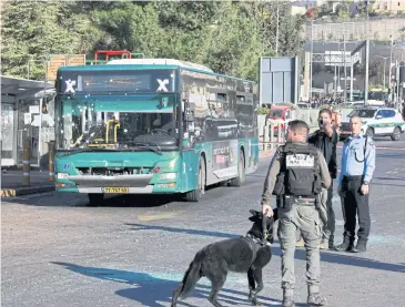  ?? AFP ?? Israeli security forces gather at the scene of an explosion at a bus stop in Jerusalem yesterday.