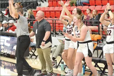  ?? TIMES photograph by Annette Beard ?? The Lady Blackhawks on the bench rejoiced at a successful shot by teammate Telgemeier in the arena at Pea Ridge High School.